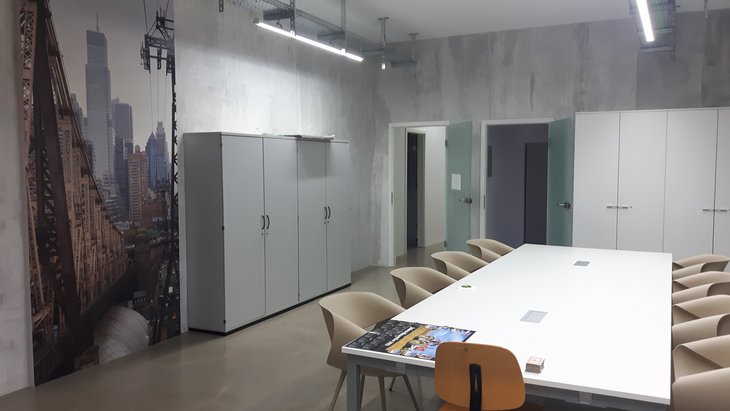 Heller Gemeinschaftsraum mit großem Tisch und Stühlen